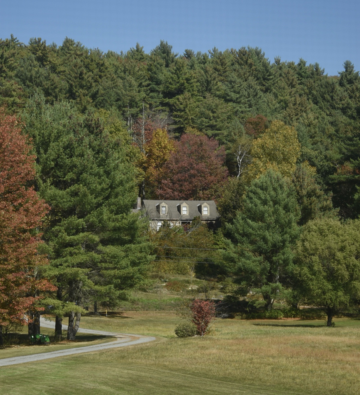 New Hampshire house surrounded by trees in the fall
