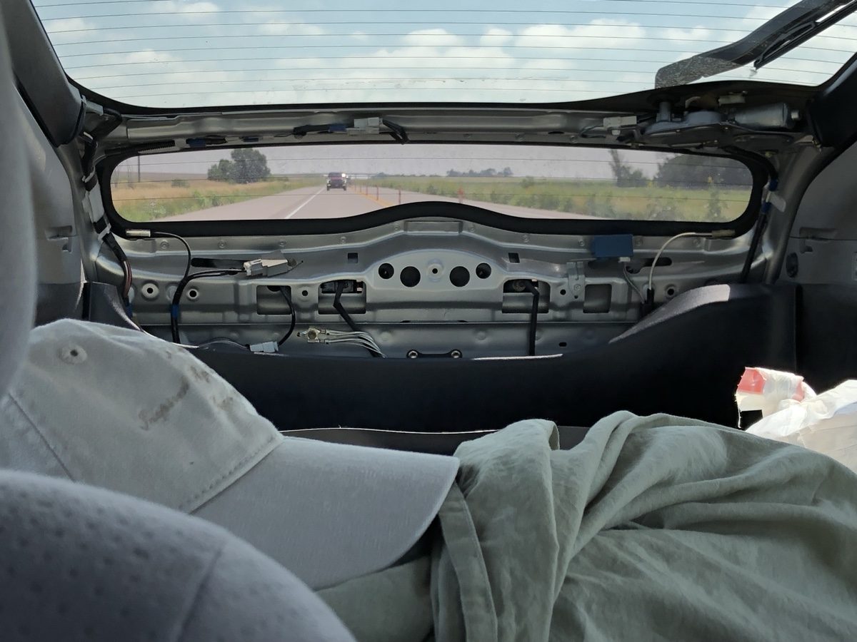 Broken trunk of a Prius on a roadtrip